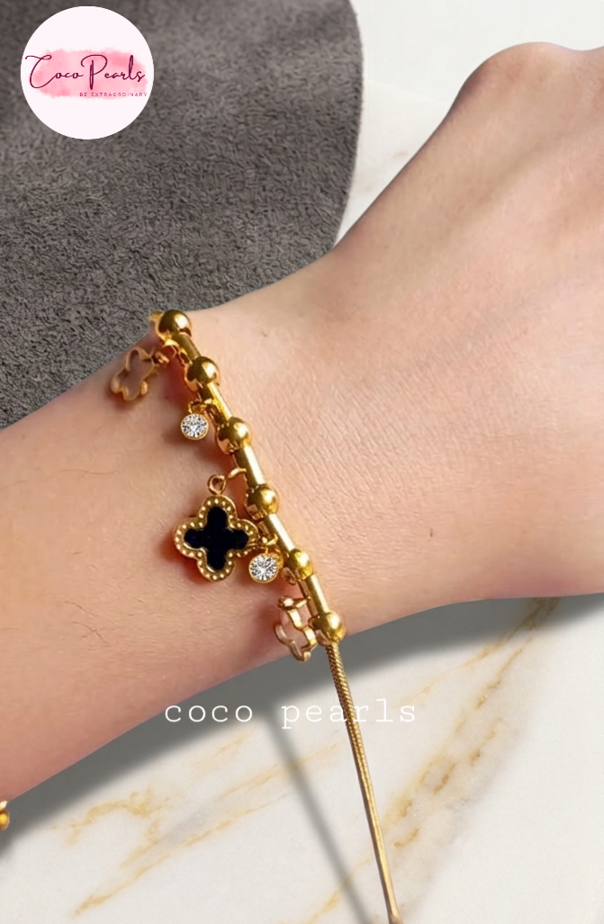 Coco pearls stainless Steel anti tarnish Gold bracelet with black clover charm on a wrist