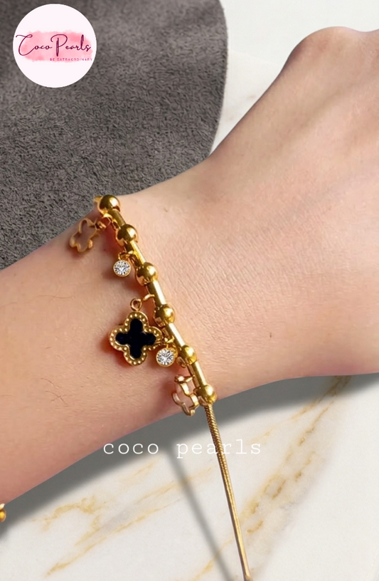 Coco pearls stainless Steel anti tarnish Gold bracelet with black clover charm on a wrist