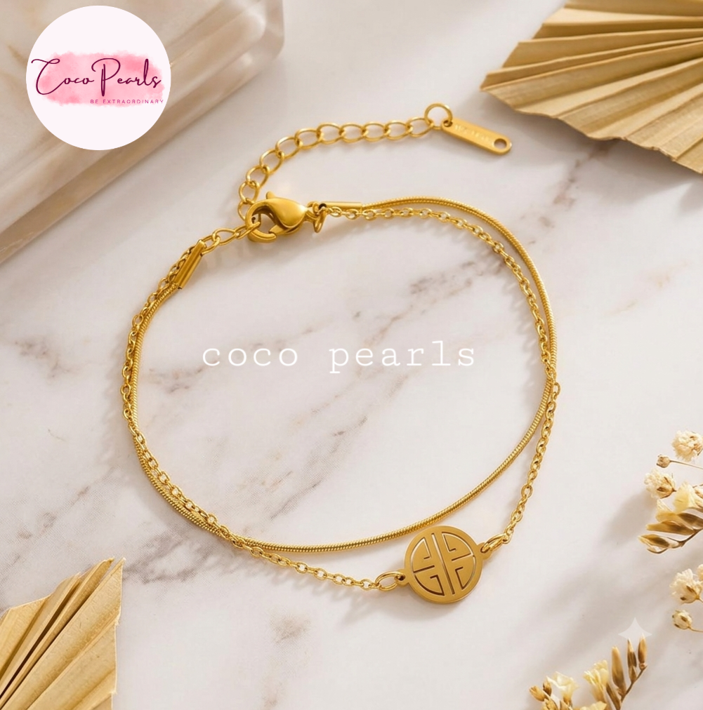 Coco pearls stainless Steel anti tarnish gold coco hui bracelet with two chains displayed on simple background 