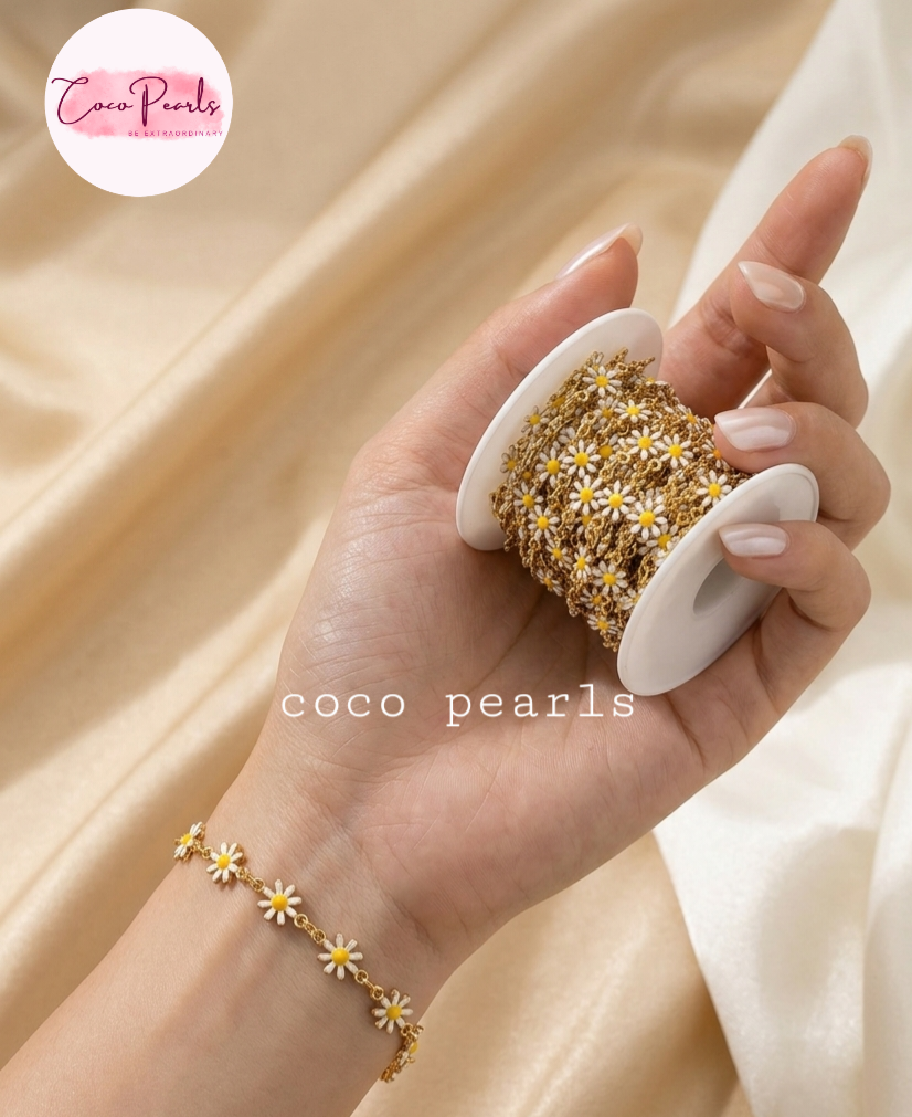 Coco pearls stainless Steel anti tarnish gold  daisy chain with white flowers and yellow center displayed on hand