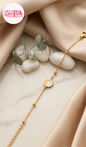 Coco pearls stainless Steel anti tarnish gold daisy flower motif bracelet displayed on simple background 