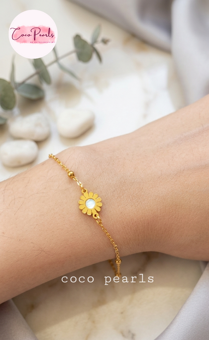 Coco pearls stainless Steel anti tarnish Gold bracelet with a sunflower charm on a wrist
