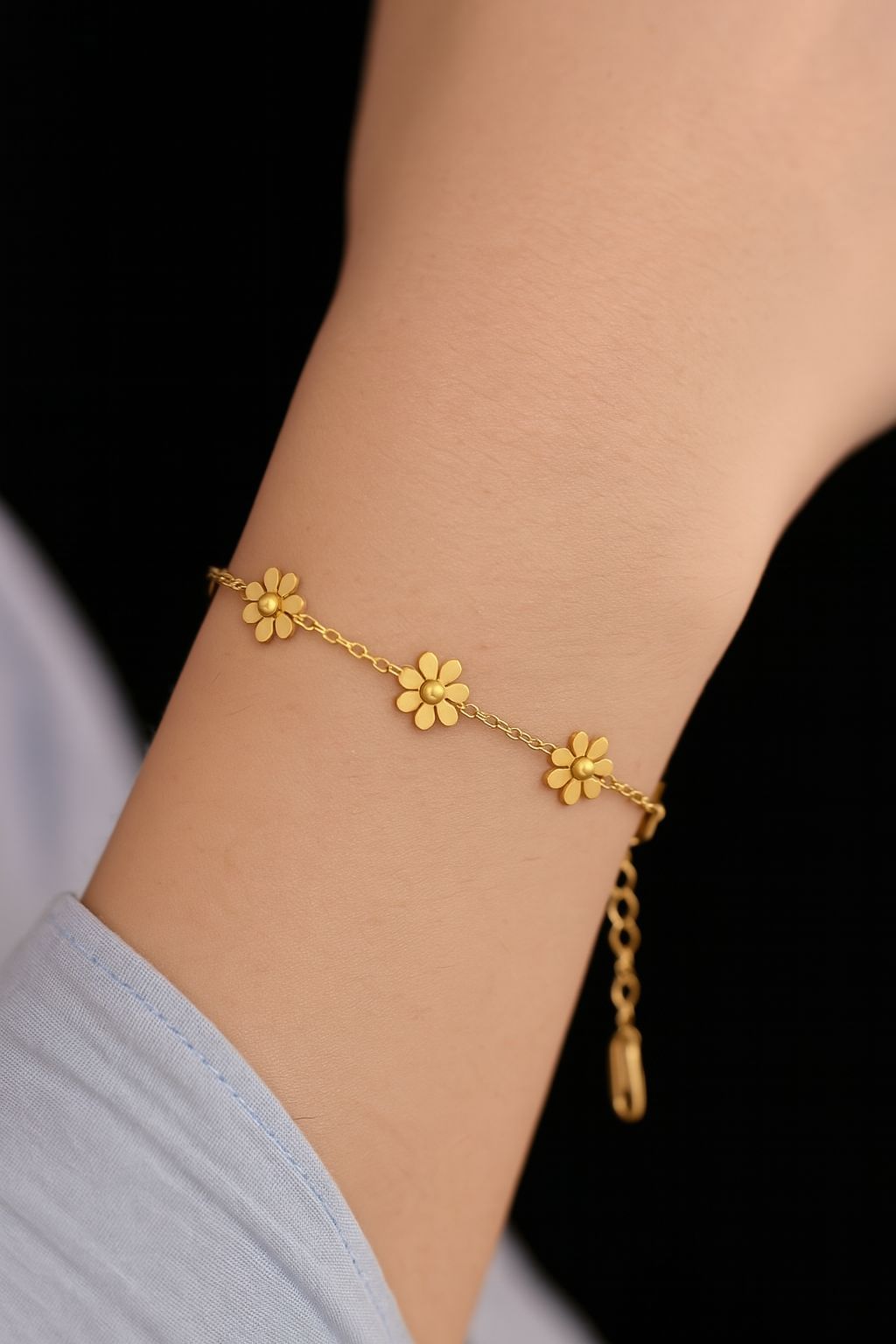 Coco pearls stainless steel anti tarnish Gold flower bracelet on a wrist with a blurred background
