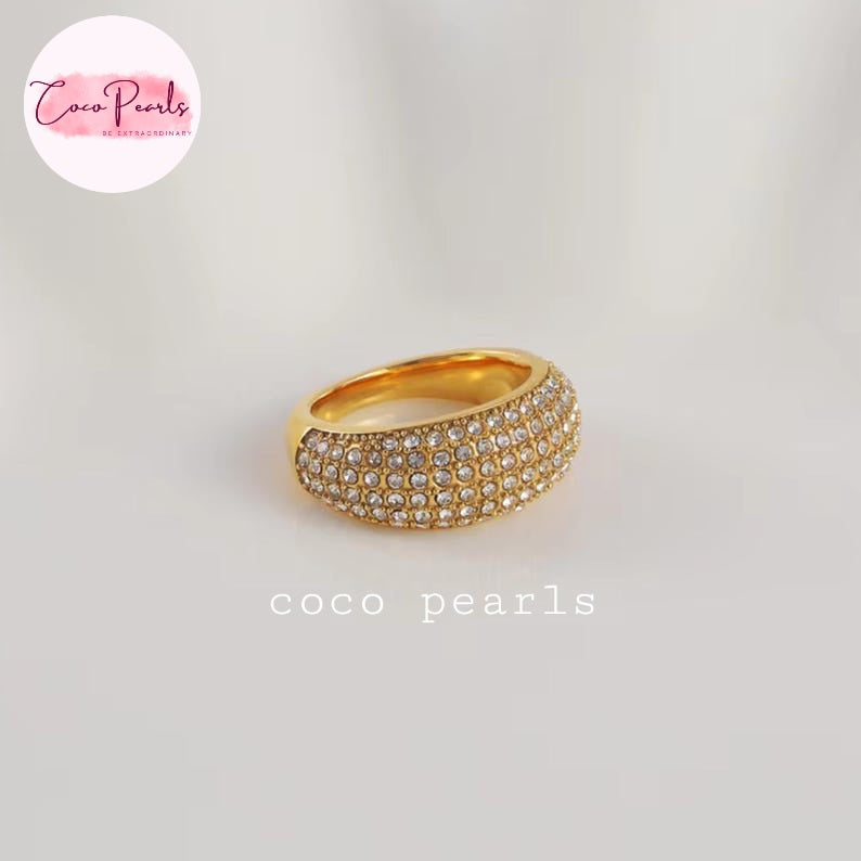 Coco pearls stainless Steel anti tarnish gold ring with two rows of clear pavé-set stones, photographed on a light neutral background. 