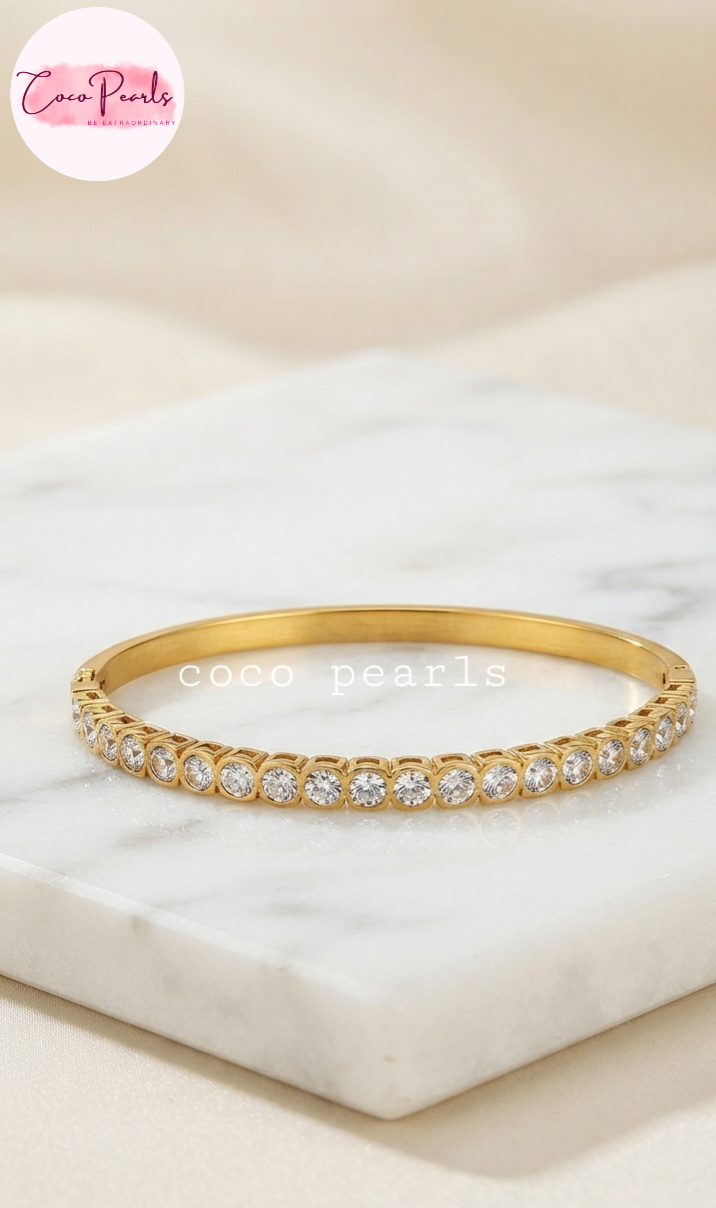 Coco pearls stainless Steel anti tarnish gold diamond accent handcuff displayed on simple background 