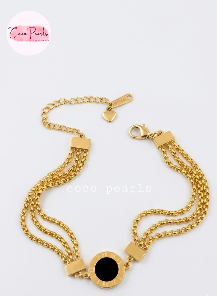 Coco pearls stainless Steel anti tarnish Gold chain bracelet with a black center on a white background