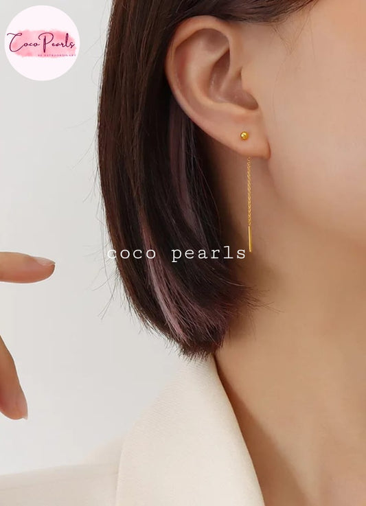 Coco pearls stainless Steel anti tarnish close-up of a model's ear wearing a delicate gold dangle earring with a small round pearl-like stud.