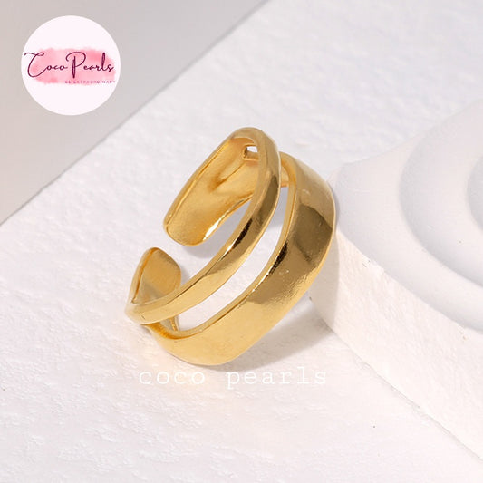 Coco pearls stainless Steel anti tarnish gold dual wave ring displayed on simple background 