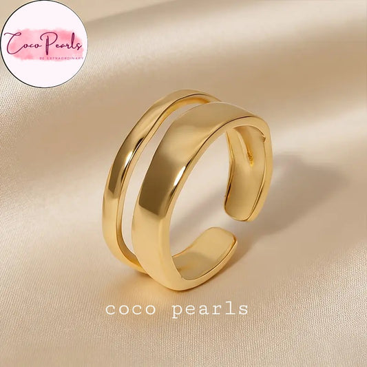 Coco pearls stainless Steel anti tarnish gold dual wave ring displayed on simple background 