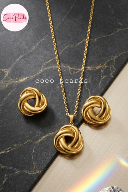 Coco pearls stainless Steel anti Gold eternity Loop jewelry set with necklace and earrings on a marble surface