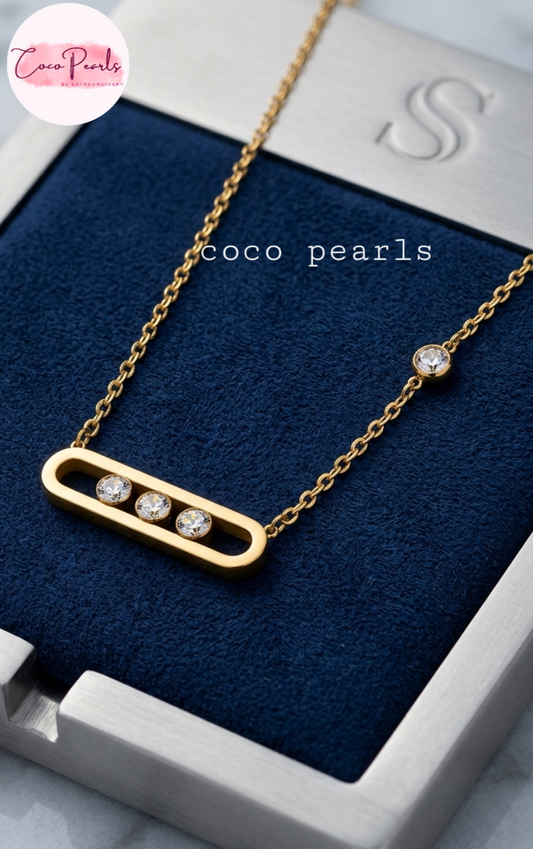 Coco pearls stainless Steel anti tarnish Gold necklace with three diamonds on a blue cushion, branded 'Coco Pearls'.