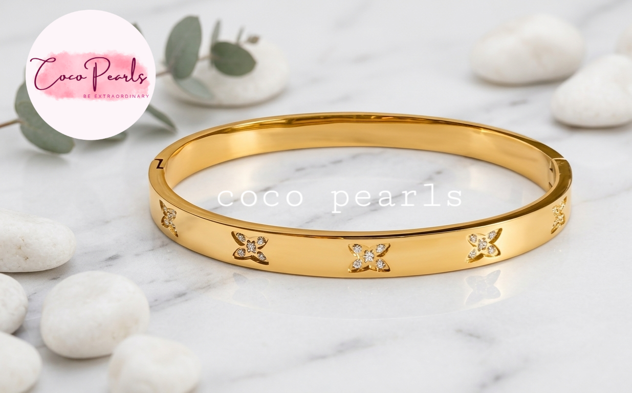 Coco pearls stainless Steel anti tarnish gold  flutter diamond studded handcuff displyed on simple background 