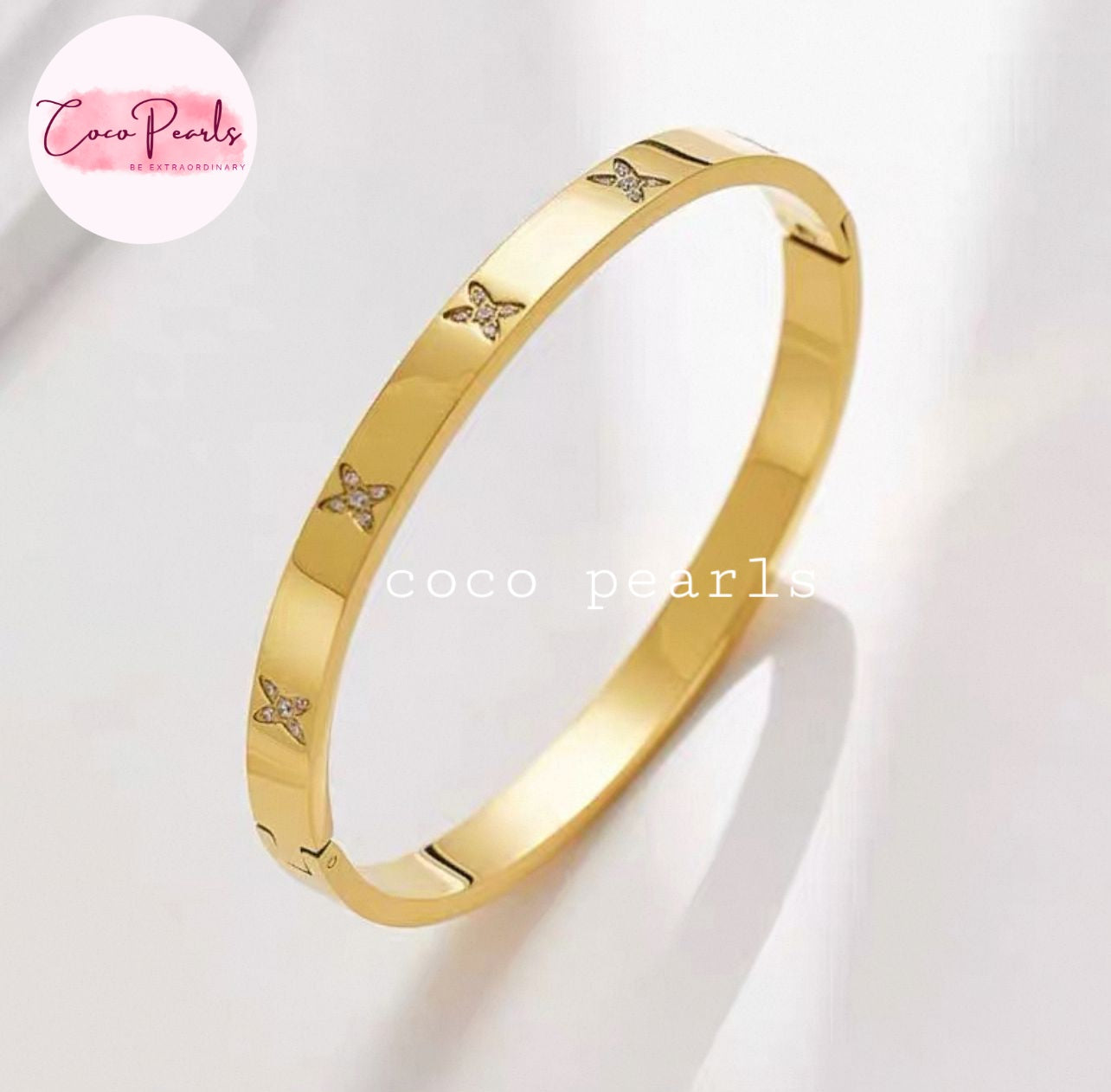 Coco pearls stainless Steel anti tarnish gold flutter handcuff displyed on simple background 