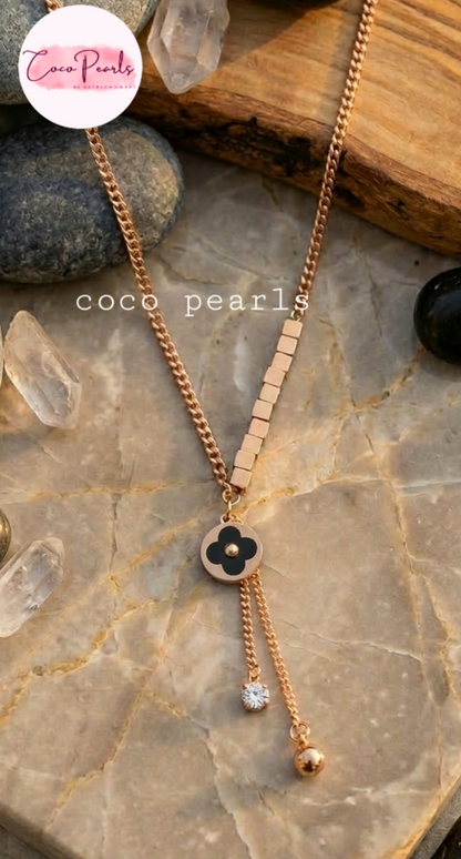 coco pearls stainless steel anti tarnish waterproof Fortune Clover Charm Necklace with hangings displayed on a simple background