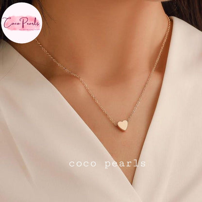 Coco pearls stainless Steel anti tarnish delicate gold chain necklace with a small heart-shaped pendant displayed on model's neck
