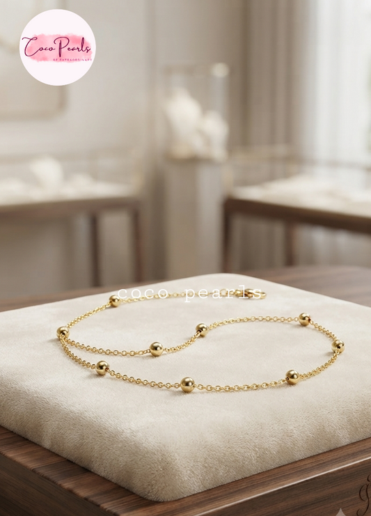 Coco pearls stainless Steel anti tarnish gold  ball chain displayed on simple background 