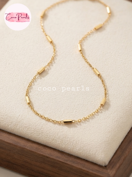 Coco pearls stainless Steel anti tarnish gold  bar chain displayed on simple background 