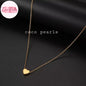 Coco pearls stainless Steel anti tarnish delicate gold chain necklace with a small polished gold heart pendant, displayed on a dark satin fabric background.