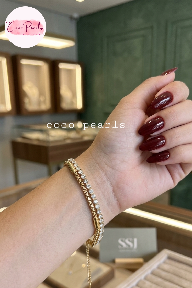 Coco Pearls Stainless steel Anti Tarnish Golden stream link bracelet with double layer chain. a diamond studded line and golden chain displayed a white background
