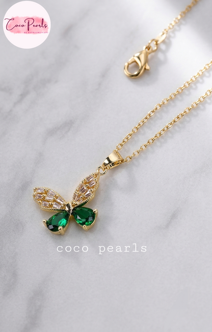 Coco pearls stainless Steel anti tarnish Gold butterfly pendant necklace with green teardrop gemstones and clear rhinestone wings.