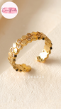 Coco pearls stainless Steel anti tarnish gold open cuff ring featuring a continuous honeycomb pattern with small clear stones, photographed on a soft cream surface. 