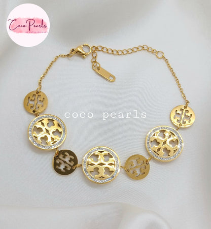 Coco Pearls Stainless steel anti tarnish Gold sparkly vibe bracelet  with circular diamond studded designs on a white background
