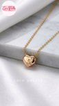 Coco pearls stainless Steel anti tarnish gold heart-shaped pendant necklace with a small diamond-like crystal cluster on the front, displayed on a white marble