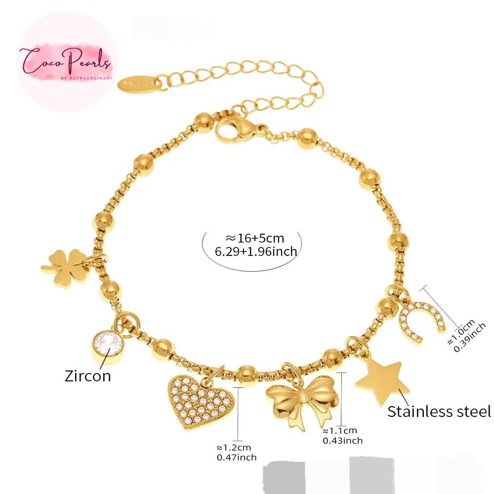 Coco pearls stainless Steel anti tarnish Gold-tone beaded charm bracelet with multiple charms including a heart, bow, star, clover, crescent moon, and a clear zircon stone, shown on a white background with size and material labels.