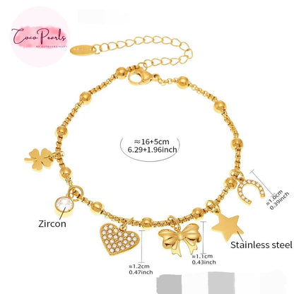 Coco pearls stainless Steel anti tarnish Gold-tone beaded charm bracelet with multiple charms including a heart, bow, star, clover, crescent moon, and a clear zircon stone, shown on a white background with size and material labels.