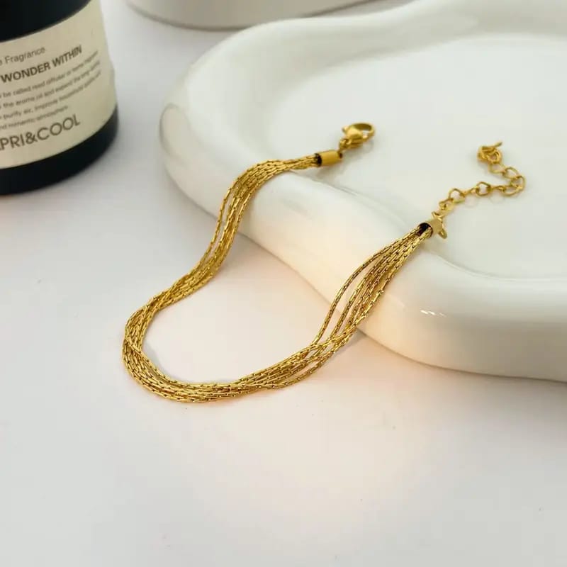 Coco pearls stainless Steel anti tarnish gold thread bracelet displayed on simple background 