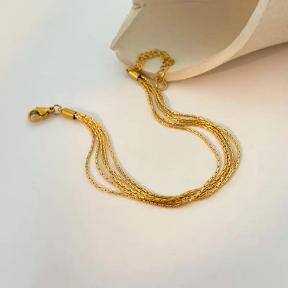 Coco pearls stainless Steel anti tarnish gold  thread bracelet displayed on simple background 