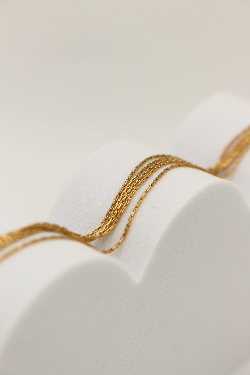 Coco pearls stainless Steel anti tarnish gold luxe thread bracelet with gold thread like design displayed on simple background 