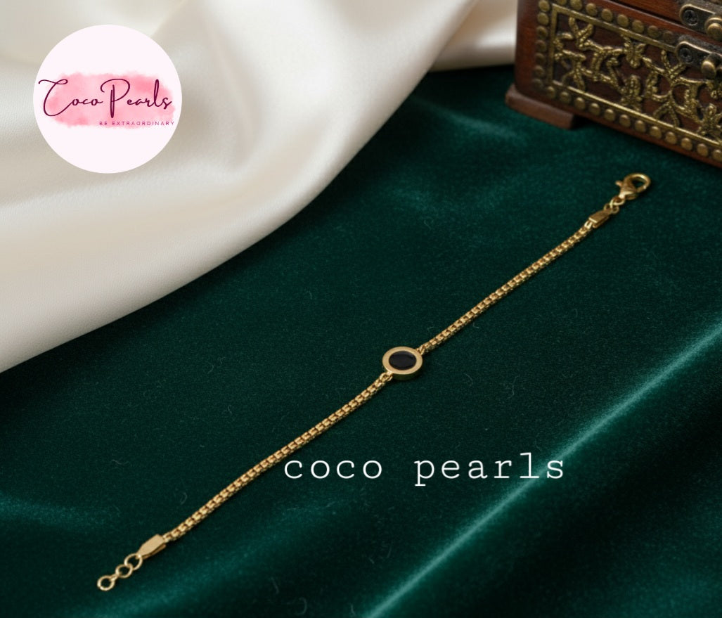 Coco Pearls stainless steel anti tarnish Gold midnight aura bracelet on a green fabric background
