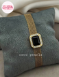 Coco pearls stainless Steel anti tarnish gold mesh bracelet watch with a rectangular black gemstone bezel set with clear crystals, displayed on a gray plush pillow. 