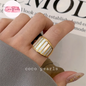 Coco pearls stainless Steel anti tarnish close-up of a hand wearing a wide gold ring with white pearl inlays