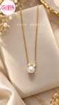 Coco pearls stainless Steel anti tarnish gold chain necklace with a white pearl pendant and small clear stones, displayed on a cream jewelry stand.