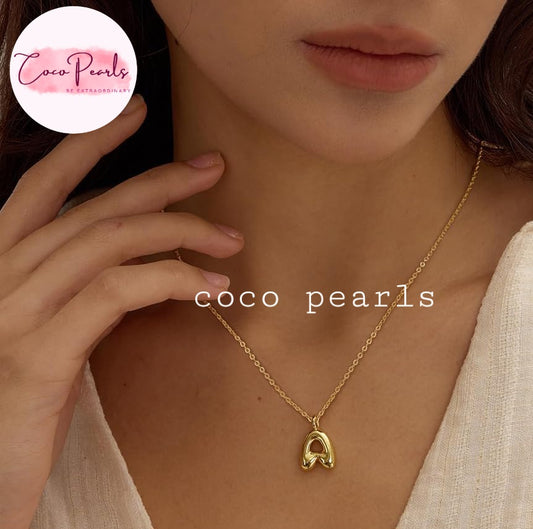 Coco pearls stainless Steel anti tarnish close-up of a model wearing a delicate gold chain necklace with letter 'A' pendant.