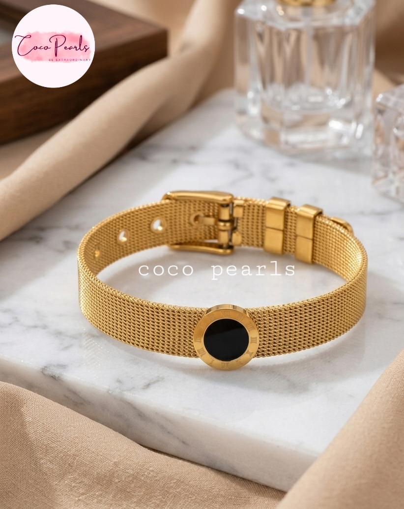 Coco pearls stainless Steel anti tarnish Gold bracelet with black center on marble surface