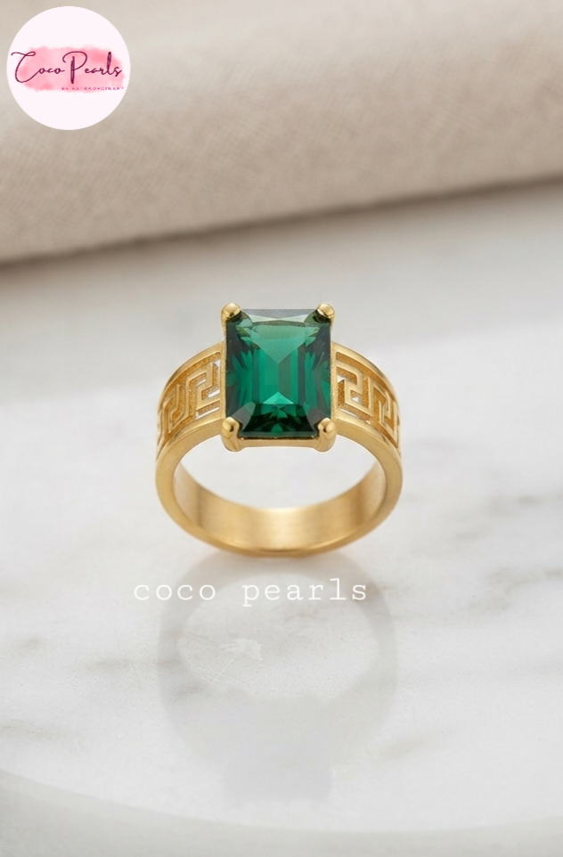 Coco pearls stainless Steel anti tarnish gold royal emerald ring displayed on simple background 