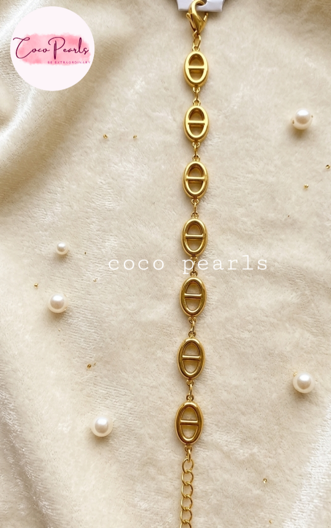 Coco pearls stainless Steel anti tarnish gold  royal loop bracelet displayed on simple background 