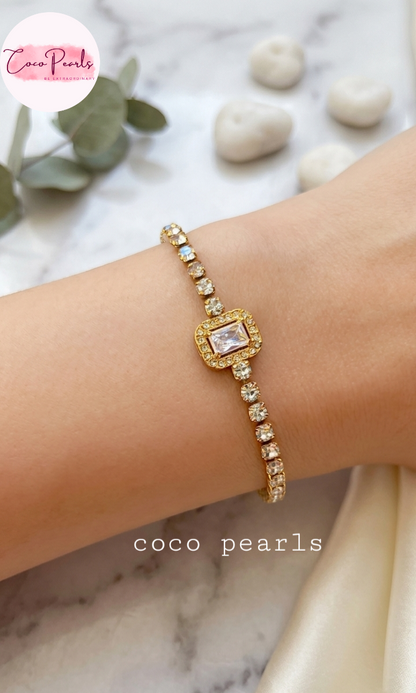 Coco pearls stainless Steel anti tarnish Gold bracelet with a central gemstone on a wrist, against a marble background