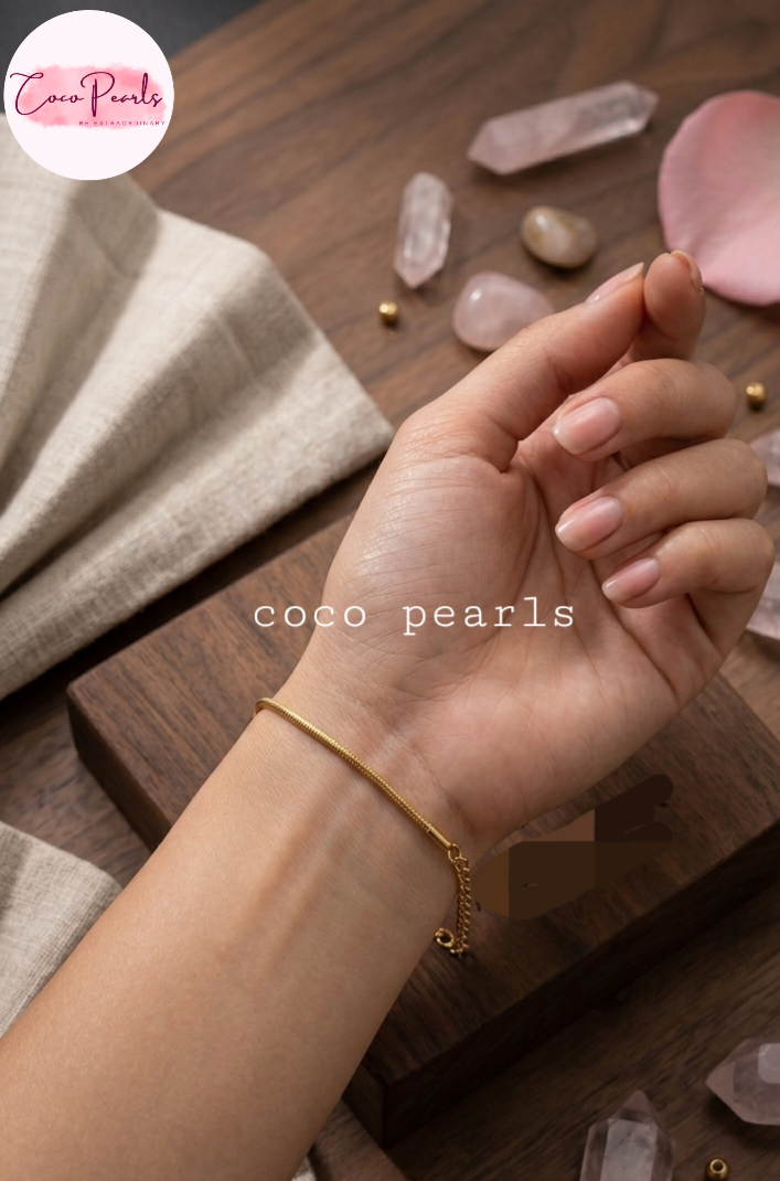 Coco pearls stainless Steel anti tarnish gold chain bracelet worn on a person's wrist