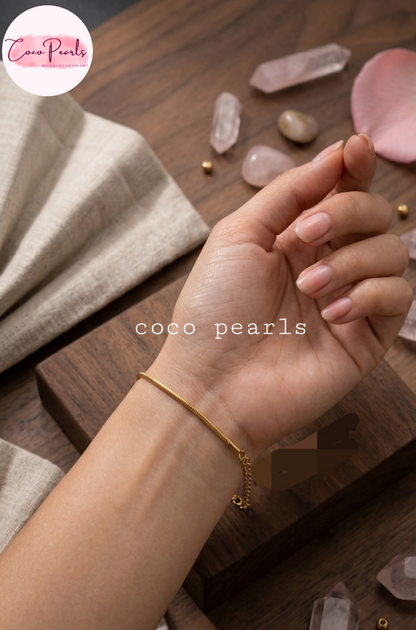 Coco pearls stainless Steel anti tarnish gold chain bracelet worn on a person's wrist