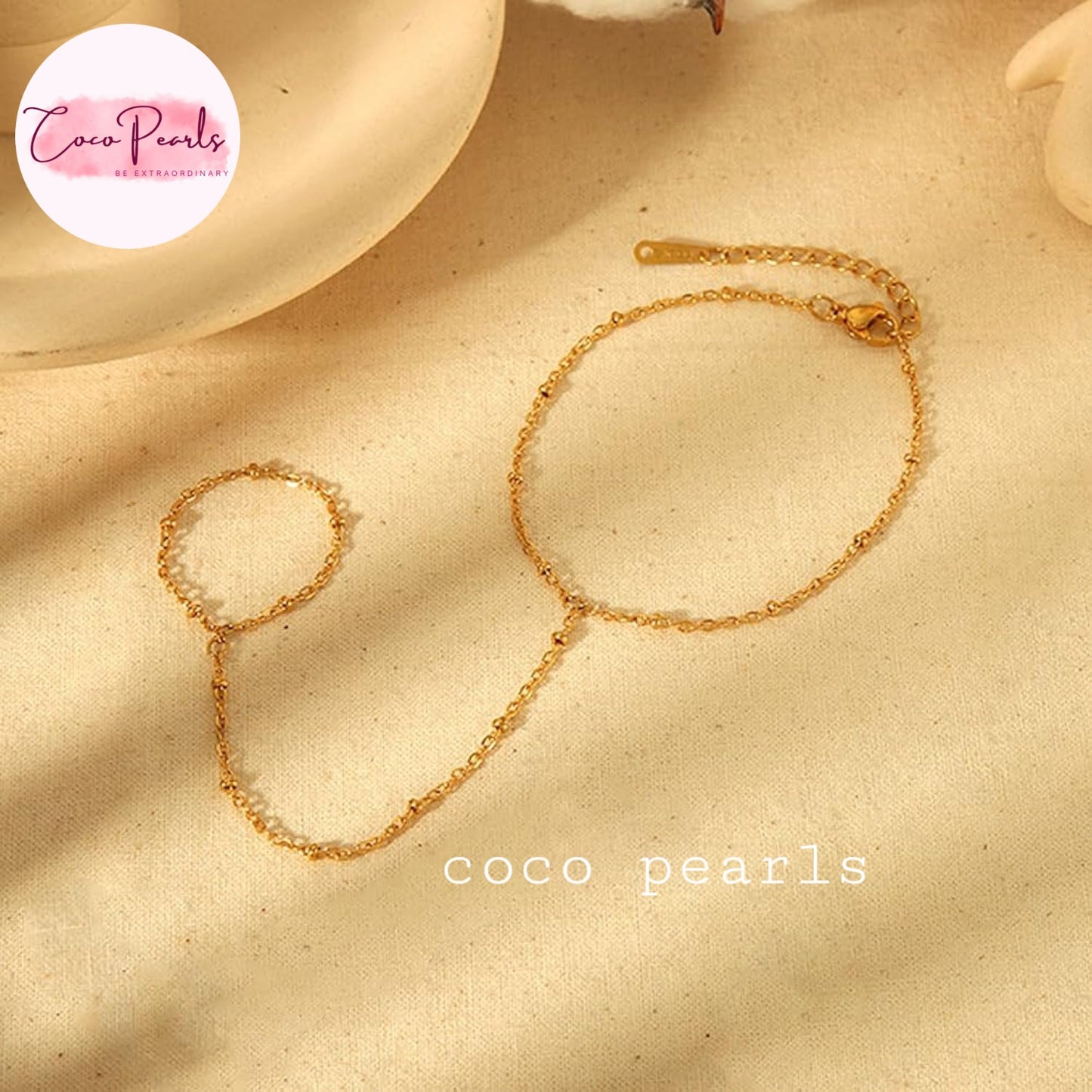 Coco pearls stainless Steel anti tarnish gold small ball chain hand harness displayed on simple background 
