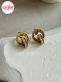 Coco pearls stainless Steel anti tarnish pair of gold-toned hoop earrings with clear rhinestone accents, displayed on a textured white surface. 
