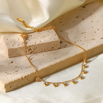 Coco pearls stainless Steel anti tarnish gold  diamond studded ball chain bracelet displayed on simple background 