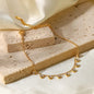 Coco pearls stainless Steel anti tarnish gold  diamond studded ball chain bracelet displayed on simple background 