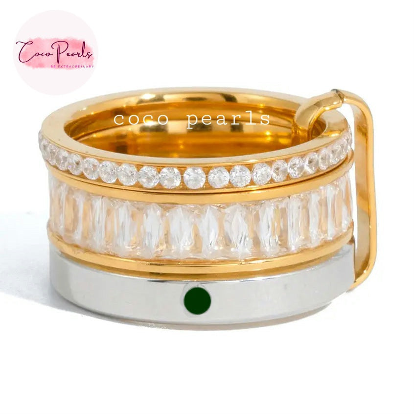 Coco pearls stainless Steel anti tarnish gold-plated ring with a clear crystal-encrusted band and a silver-colored base featuring a small green oval accent, shown on a white background