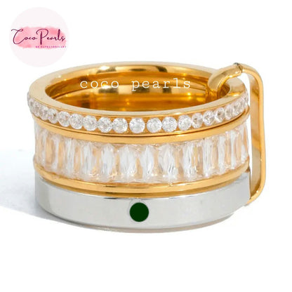 Coco pearls stainless Steel anti tarnish gold-plated ring with a clear crystal-encrusted band and a silver-colored base featuring a small green oval accent, shown on a white background