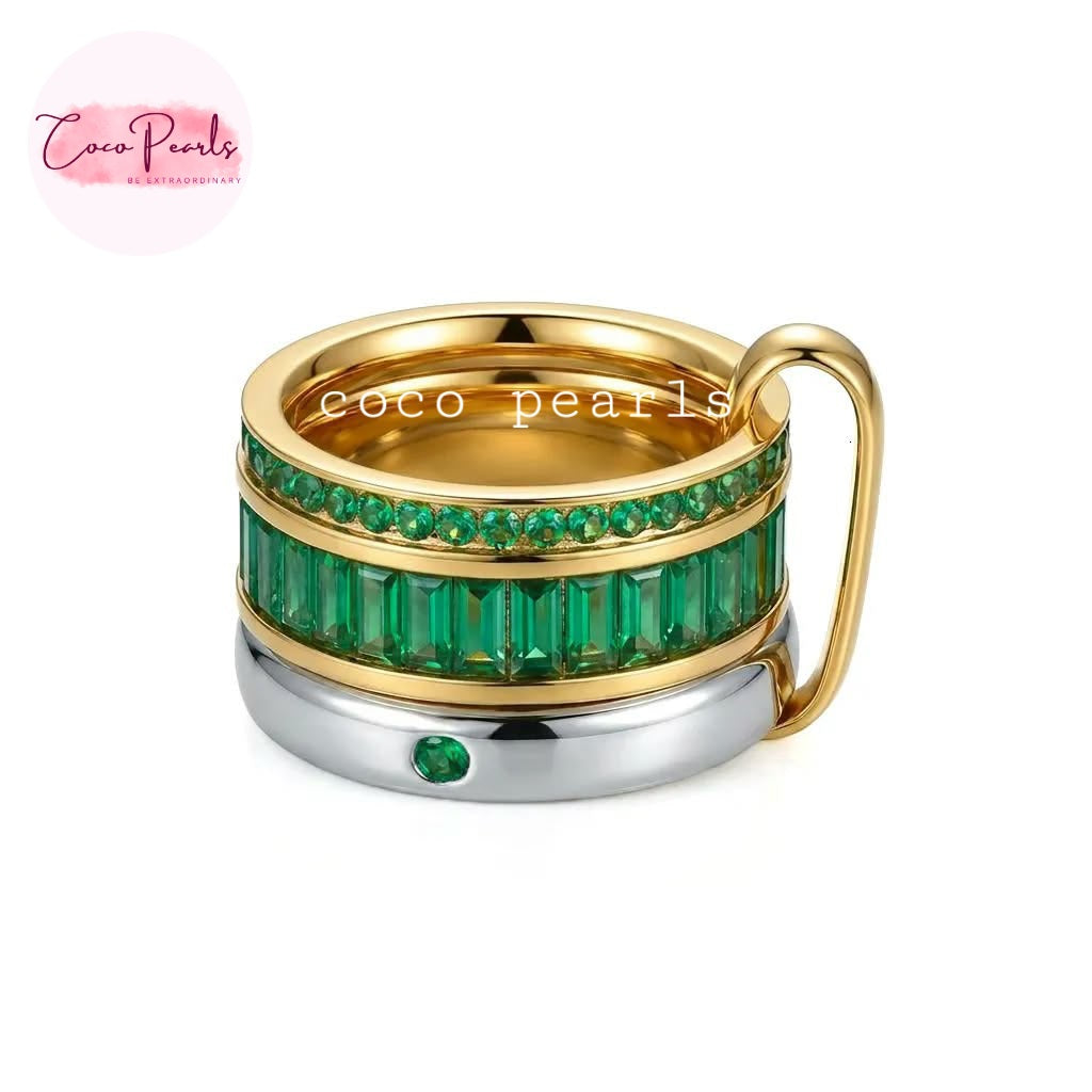 Coco pearls stainless Steel anti tarnish three-band stacked ring by featuring a gold top band, a middle band with green baguette-cut crystals and a row of round green stones, and a silver bottom band with a single green accent stone.